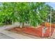 Charming home featuring a lush front yard with mature tree and well-maintained landscaping at 4848 S Pitkin Way, Aurora, CO 80015