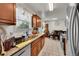Bright kitchen with tile floors and granite countertops with view of the dining area at 4848 S Pitkin Way, Aurora, CO 80015