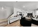Bright living room featuring hardwood floors, comfortable seating, and a staircase at 4848 S Pitkin Way, Aurora, CO 80015