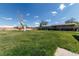 Large backyard with mature landscaping, a covered deck, and privacy fence at 14347 E 134Th Ave, Brighton, CO 80601