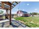 Two-story barn featuring white garage doors and red siding stands on a lush green lawn at 14347 E 134Th Ave, Brighton, CO 80601