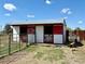 Exterior view of a barn with red and white trim, fenced enclosure at 14347 E 134Th Ave, Brighton, CO 80601