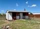 Exterior view of a barn with red and white trim and a group of goats in a fenced enclosure at 14347 E 134Th Ave, Brighton, CO 80601