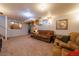 Basement living area with carpet flooring, comfortable couches, and updated decor at 14347 E 134Th Ave, Brighton, CO 80601