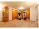 Open basement area features carpet flooring, an antique cabinet, and exercise equipment at 14347 E 134Th Ave, Brighton, CO 80601