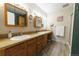 Bright bathroom with double sink vanity and wood cabinets at 14347 E 134Th Ave, Brighton, CO 80601