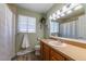 Well-lit bathroom features a single sink vanity, linoleum floors, and an updated color scheme at 14347 E 134Th Ave, Brighton, CO 80601