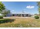 Well-maintained single story home with a brick facade, large front yard, and mature trees at 14347 E 134Th Ave, Brighton, CO 80601