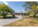 Charming single-story home with a circle drive, mature trees, and large front yard at 14347 E 134Th Ave, Brighton, CO 80601