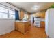 Well-lit kitchen offering wood cabinets, white appliances, and hardwood floors at 14347 E 134Th Ave, Brighton, CO 80601