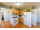 Bright kitchen featuring wood cabinets, white appliances, and laminate flooring at 14347 E 134Th Ave, Brighton, CO 80601