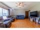 Cozy living room with hardwood floors, ceiling fan, and comfortable seating at 14347 E 134Th Ave, Brighton, CO 80601