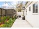 Charming backyard featuring an outdoor seating area, string lights, garden and small architectural details at 1884 S Ivy St, Denver, CO 80224