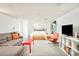 Spacious basement area with a sofa, bed, and entertainment setup for relaxed living at 1884 S Ivy St, Denver, CO 80224