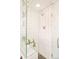 Modern bathroom featuring a glass-enclosed shower, white tile, and a sleek vanity at 1884 S Ivy St, Denver, CO 80224