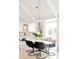 Dining area with modern light fixture and kitchen bar seating at 1884 S Ivy St, Denver, CO 80224