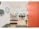 Bright foyer with hardwood floors, leading to an open-concept living and kitchen area at 1884 S Ivy St, Denver, CO 80224