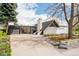 Modern home with white exterior, mature landscaping, and striking architectural details at 1884 S Ivy St, Denver, CO 80224