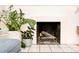Close-up of a cozy white brick fireplace with tiled hearth at 1884 S Ivy St, Denver, CO 80224