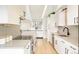 Bright kitchen featuring white cabinets, modern appliances, and an abundance of counter space at 1884 S Ivy St, Denver, CO 80224