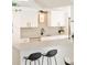Bright kitchen showcasing sleek white cabinets, modern appliances, and a light countertop breakfast bar at 1884 S Ivy St, Denver, CO 80224