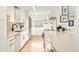 Bright kitchen featuring white cabinets, modern appliances, and an abundance of counter space at 1884 S Ivy St, Denver, CO 80224