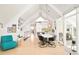 Open-concept living room featuring vaulted ceilings, light wood floors, and stylish modern furnishings at 1884 S Ivy St, Denver, CO 80224