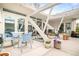 Charming patio with a dining set, lounge chairs, potted plants, and modern architectural details at 1884 S Ivy St, Denver, CO 80224