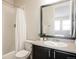 Bathroom featuring a black framed mirror, vanity and a shower with white curtain at 27274 E Lakeview Pl, Aurora, CO 80016