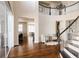 Bright foyer with hardwood floors, staircase, and views into the living and dining spaces at 27274 E Lakeview Pl, Aurora, CO 80016