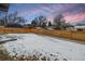 Spacious backyard with a wooden fence and snowy ground at 3289 S Eudora St, Denver, CO 80222