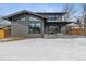 Modern home with gray siding, snowy backyard, and wooden fence at 3289 S Eudora St, Denver, CO 80222