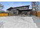 Contemporary home with gray siding, snowy backyard, and wooden fence at 3289 S Eudora St, Denver, CO 80222