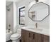 Modern bathroom with white subway tile, a soaking tub, and a wood vanity at 3289 S Eudora St, Denver, CO 80222