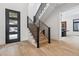 Light and airy entryway with modern staircase and hardwood floors at 3289 S Eudora St, Denver, CO 80222