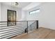 Elegant upper landing with modern light fixture and metal railing at 3289 S Eudora St, Denver, CO 80222