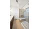 Modern bathroom with a glass-enclosed shower featuring a built-in bench and neutral tile at 14700 E 104Th Ave # 805, Commerce City, CO 80022
