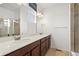 Modern bathroom with a double vanity, large mirror, and tiled shower at 14700 E 104Th Ave # 805, Commerce City, CO 80022