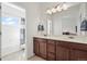 Bright bathroom features a double vanity with modern fixtures and a view of the shower/tub at 14700 E 104Th Ave # 805, Commerce City, CO 80022