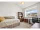 Bright bedroom with a bed, desk, and bookcase, with lots of natural light at 14700 E 104Th Ave # 805, Commerce City, CO 80022