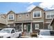 Inviting townhome exterior showcasing two-story construction with a front yard and parking at 14700 E 104Th Ave # 805, Commerce City, CO 80022