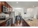 Modern kitchen with stainless steel appliances, granite counters, and dark wood cabinetry at 14700 E 104Th Ave # 805, Commerce City, CO 80022