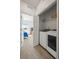 Convenient laundry room with white washer and dryer, a shelf, and a glimpse into the bedroom at 14700 E 104Th Ave # 805, Commerce City, CO 80022