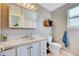 Bathroom with large vanity, storage, and traditional fixtures at 11303 Vernon Way, Parker, CO 80134
