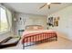 This bedroom features a ceiling fan, light carpet, and a rod iron bed frame at 11303 Vernon Way, Parker, CO 80134