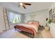 Bright bedroom with ceiling fan, large window, light carpet and rod iron bed frame at 11303 Vernon Way, Parker, CO 80134