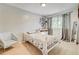 Neutral toned bedroom with patterned bedding, light carpet and a big window at 11303 Vernon Way, Parker, CO 80134