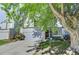 Charming two-story home with a well-manicured lawn, mature tree, and a gray two-car garage at 11303 Vernon Way, Parker, CO 80134