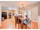Eat-in kitchen with stainless appliances, maple cabinets, tile countertop, dining area, and backyard access at 11303 Vernon Way, Parker, CO 80134