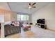 Bright living room with a gray sectional sofa and vaulted ceilings, creating an inviting space at 11303 Vernon Way, Parker, CO 80134
